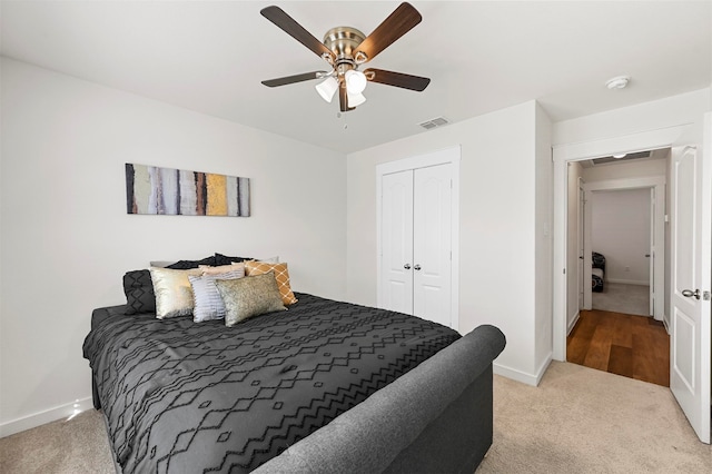 carpeted bedroom featuring a closet and ceiling fan