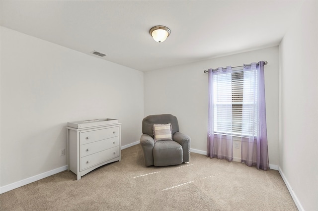 living area with light colored carpet