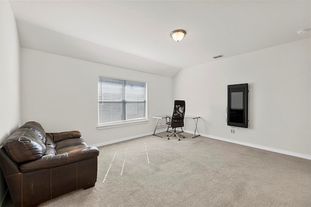 sitting room with vaulted ceiling and carpet