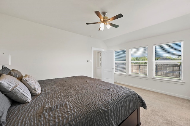 bedroom with ceiling fan, light colored carpet, and lofted ceiling