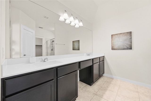 bathroom with tile patterned flooring, a shower with shower door, and vanity