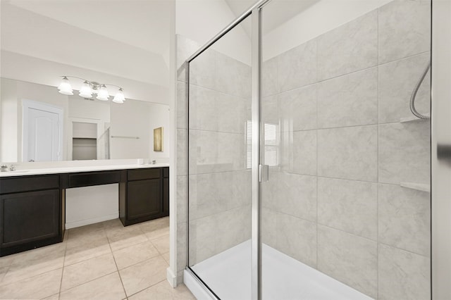 bathroom with tile patterned flooring, a shower with door, and vanity