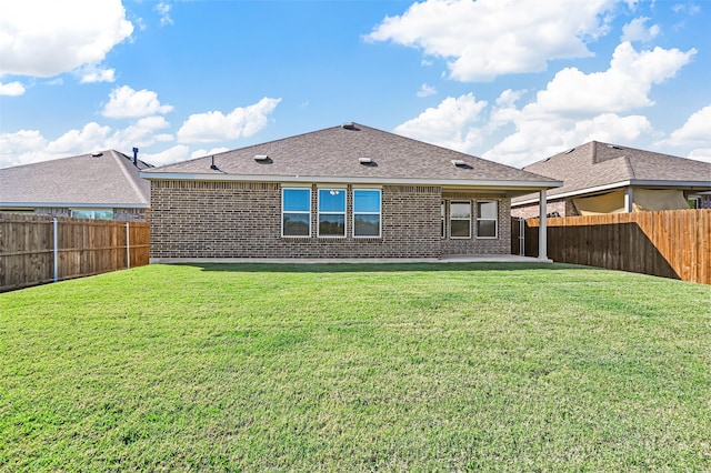 rear view of property featuring a patio area and a lawn