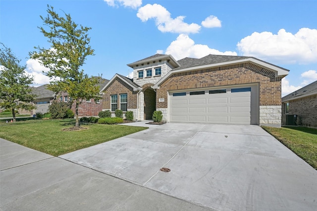 view of front facade featuring a front yard, a garage, and cooling unit