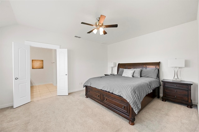 bedroom featuring lofted ceiling, light carpet, and ceiling fan