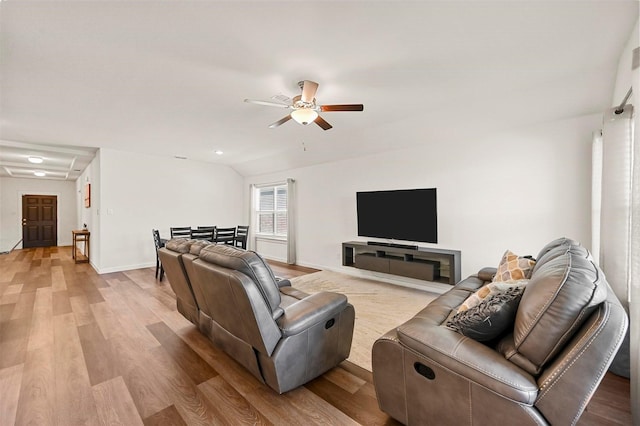 living room with light wood-type flooring, ceiling fan, and vaulted ceiling