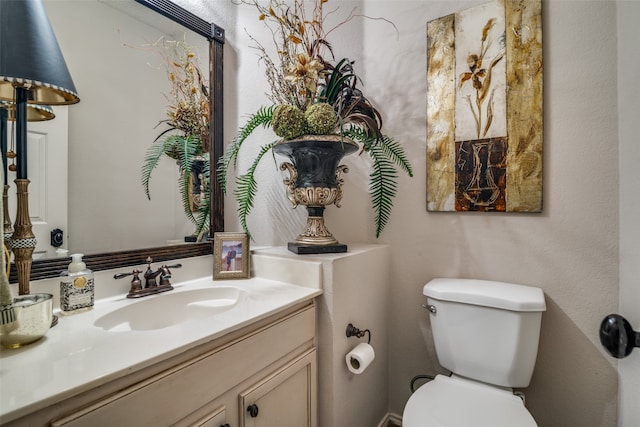 bathroom featuring toilet and vanity