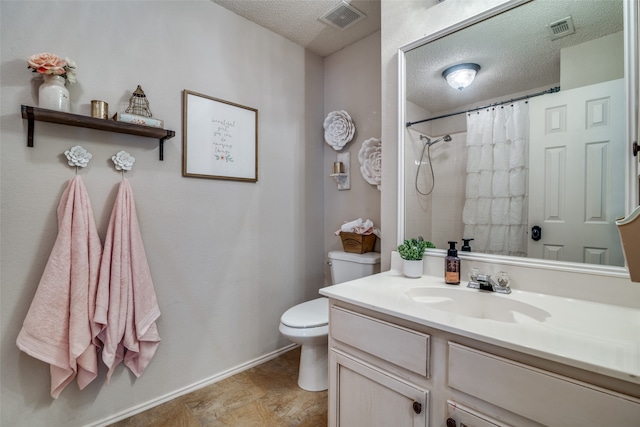 bathroom featuring vanity, toilet, a textured ceiling, and a shower with shower curtain