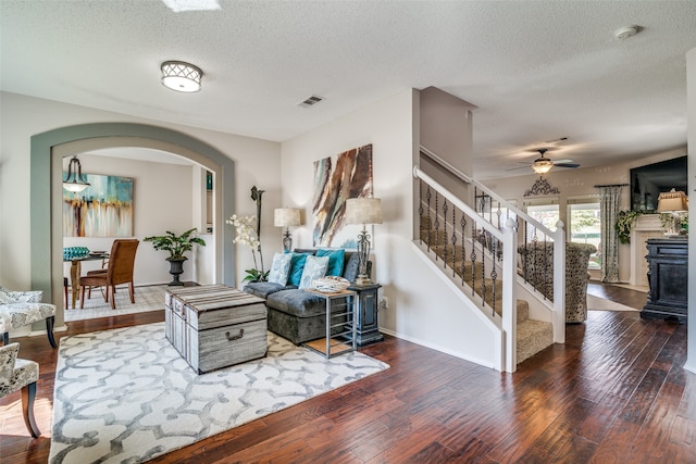 interior space featuring dark wood-type flooring, ceiling fan, and a textured ceiling