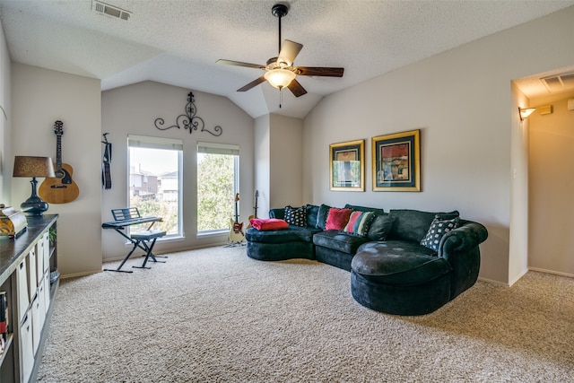 carpeted living room featuring a textured ceiling, ceiling fan, and vaulted ceiling