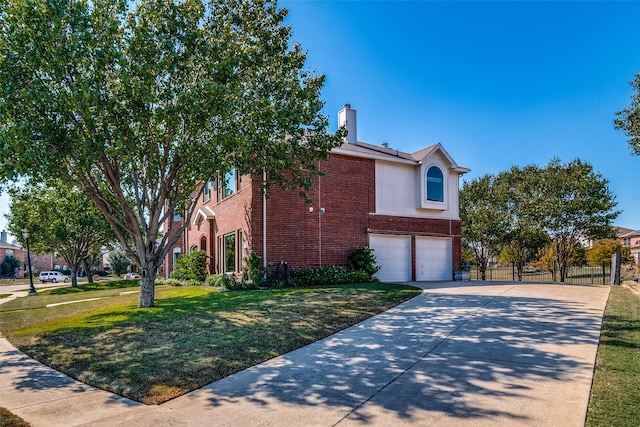 view of front of house with a front yard and a garage