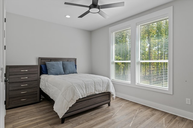 bedroom with ceiling fan and light wood-type flooring