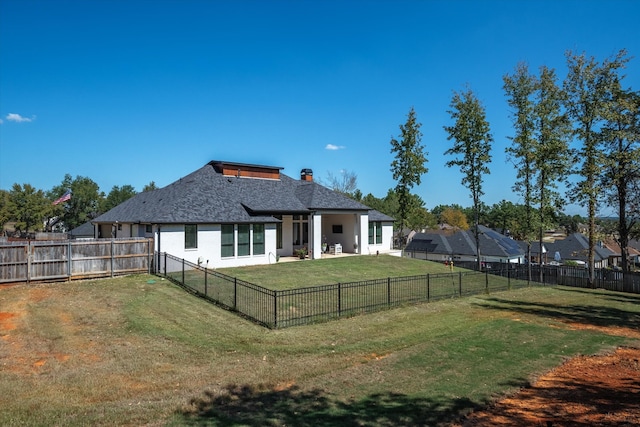 back of house featuring a patio and a lawn