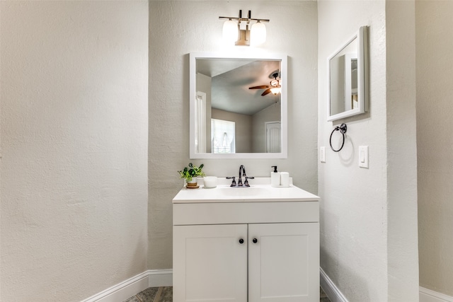 bathroom featuring vanity, lofted ceiling, and ceiling fan