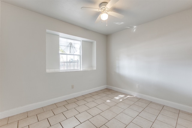 tiled spare room featuring ceiling fan