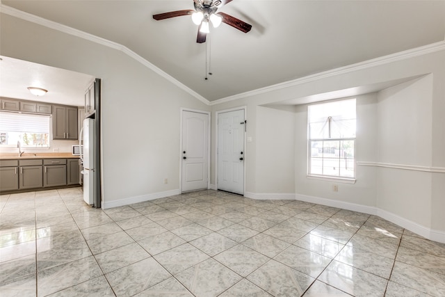 interior space featuring ornamental molding, vaulted ceiling, and ceiling fan