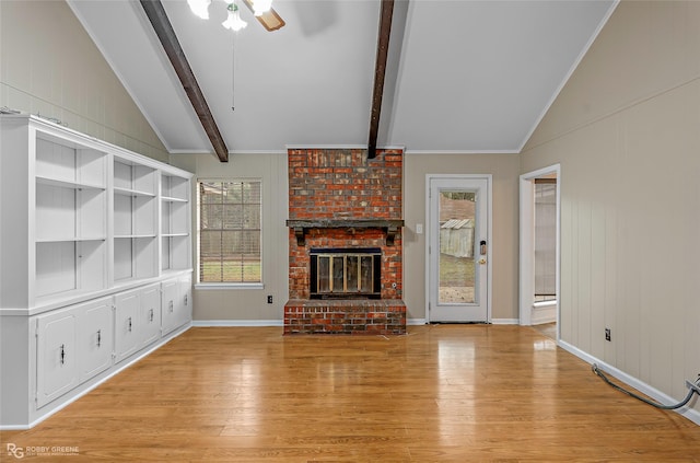 unfurnished living room featuring a ceiling fan, baseboards, light wood finished floors, vaulted ceiling with beams, and a brick fireplace