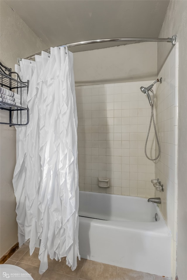 bathroom featuring shower / bath combo with shower curtain and tile patterned flooring