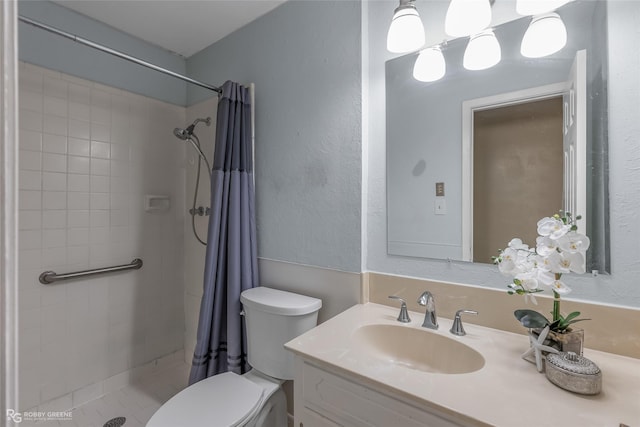 full bathroom featuring a shower stall, toilet, vanity, and a textured wall