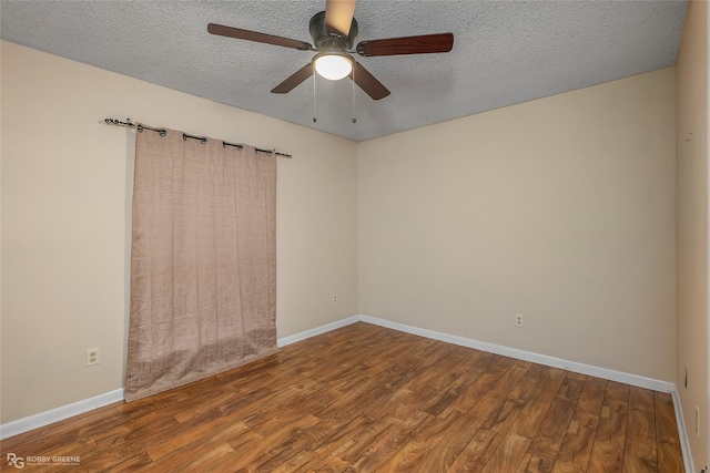 unfurnished room featuring baseboards, a textured ceiling, wood finished floors, and a ceiling fan