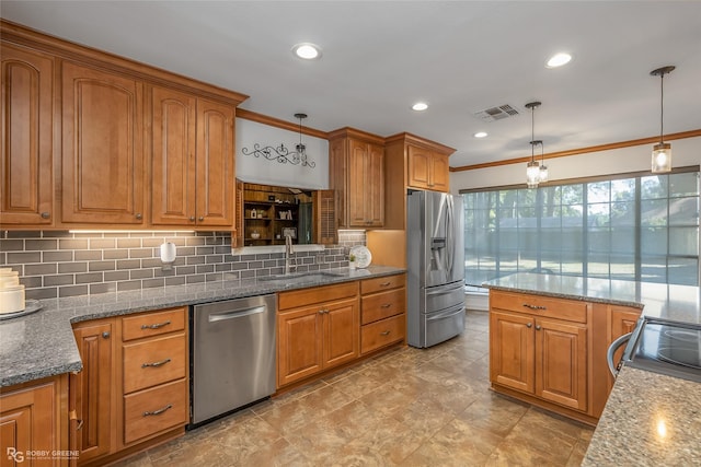 kitchen featuring brown cabinets, visible vents, appliances with stainless steel finishes, and a sink