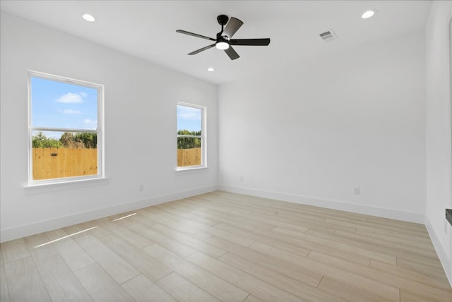 unfurnished room with light wood-type flooring and ceiling fan