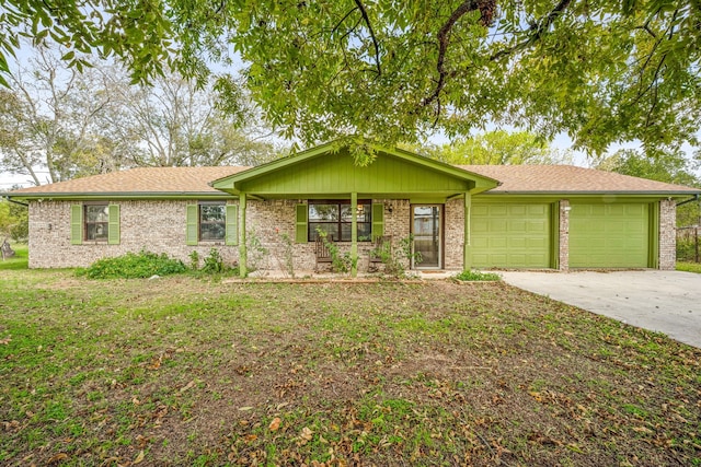 ranch-style home featuring a porch, a front yard, and a garage