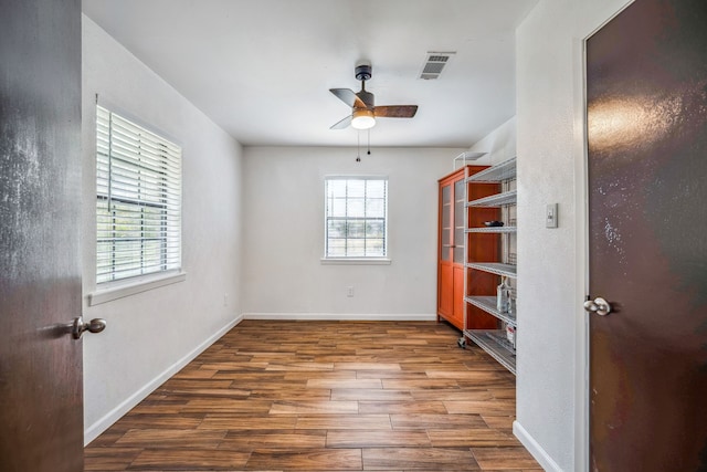 unfurnished bedroom with dark wood-type flooring and ceiling fan