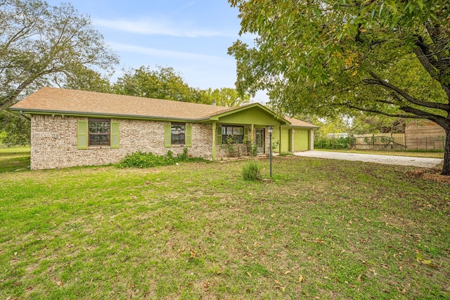 single story home featuring a front lawn and a garage