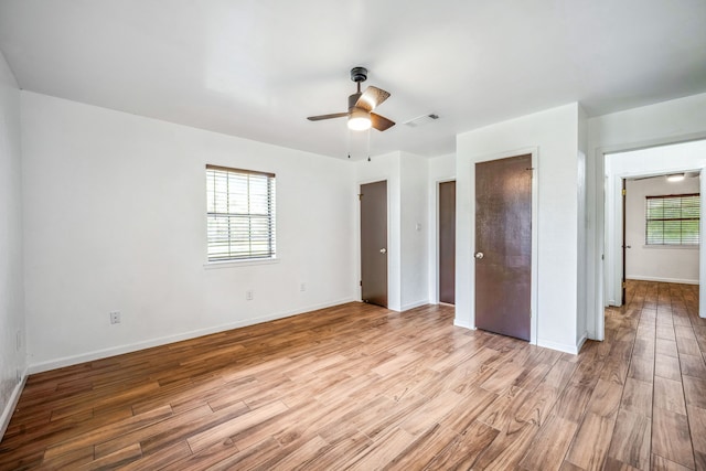 unfurnished bedroom featuring light wood-type flooring and ceiling fan