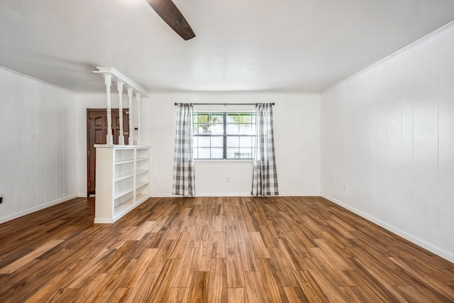 unfurnished living room with ornamental molding and hardwood / wood-style flooring