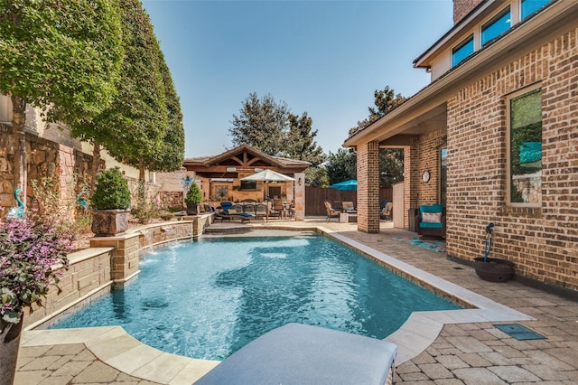 view of pool featuring pool water feature, a patio area, and an outdoor hangout area