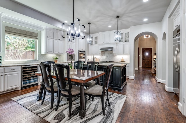 dining area with dark hardwood / wood-style flooring and beverage cooler