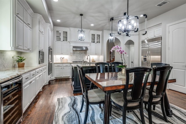 dining area featuring dark wood-type flooring and beverage cooler