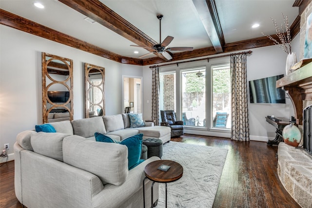 living room with a fireplace, ceiling fan, dark hardwood / wood-style flooring, and beamed ceiling