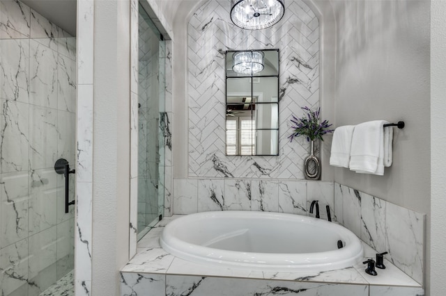 bathroom featuring separate shower and tub