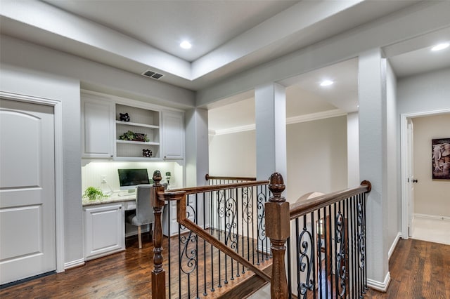 corridor featuring dark hardwood / wood-style flooring and ornamental molding