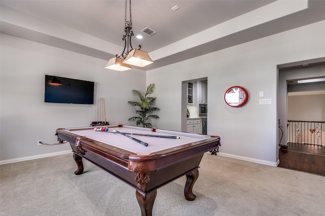 rec room with light carpet, a raised ceiling, and pool table