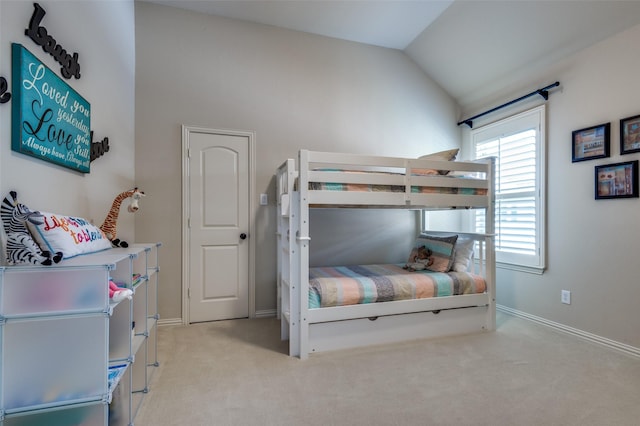 bedroom featuring light colored carpet and lofted ceiling