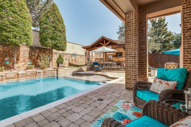 view of pool with pool water feature and a patio