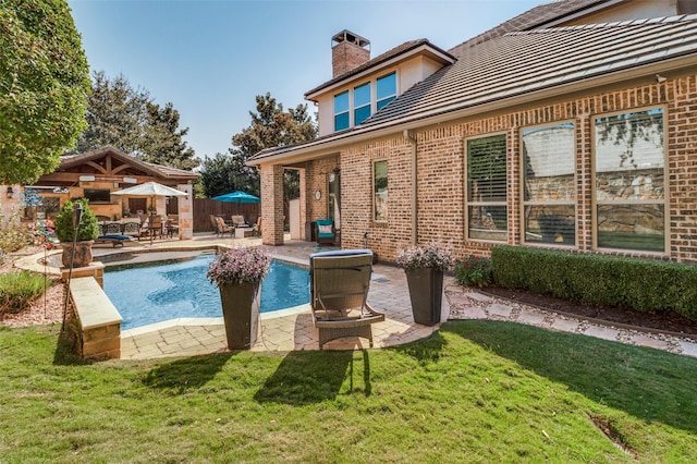 view of swimming pool with a lawn and a patio area