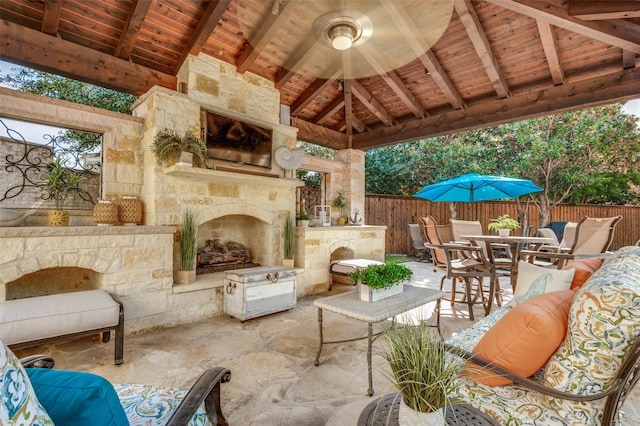 view of patio featuring an outdoor living space with a fireplace