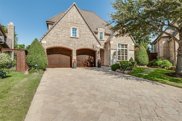 view of front facade with a garage and a front lawn