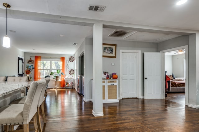 dining area with dark wood-type flooring and ceiling fan