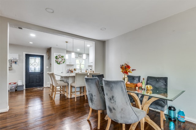 dining space with dark hardwood / wood-style flooring