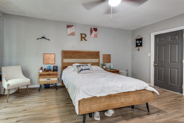 bedroom with wood-type flooring and ceiling fan