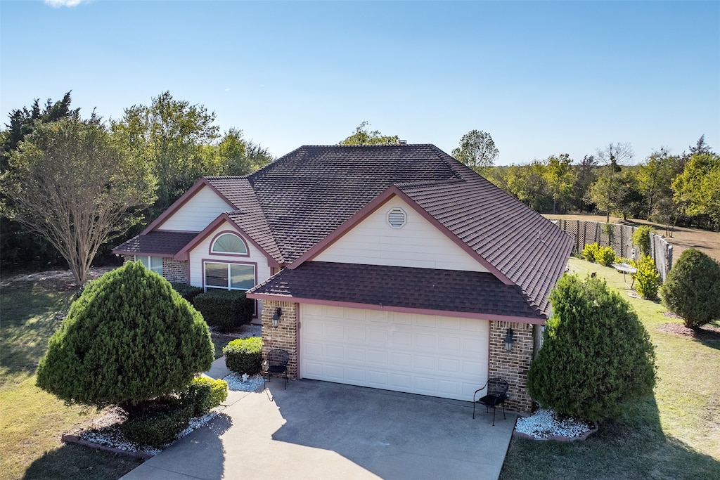 view of front of house with a front yard and a garage