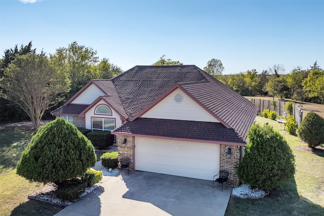 view of front of house with a front yard and a garage