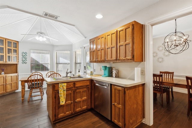 kitchen featuring ceiling fan with notable chandelier, lofted ceiling, pendant lighting, stainless steel dishwasher, and dark hardwood / wood-style floors