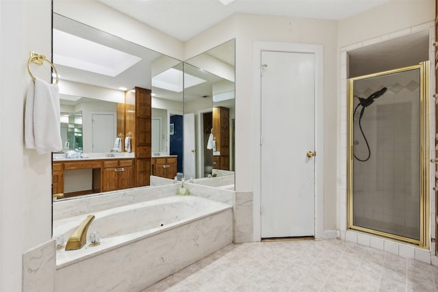 bathroom featuring vanity, shower with separate bathtub, and a skylight